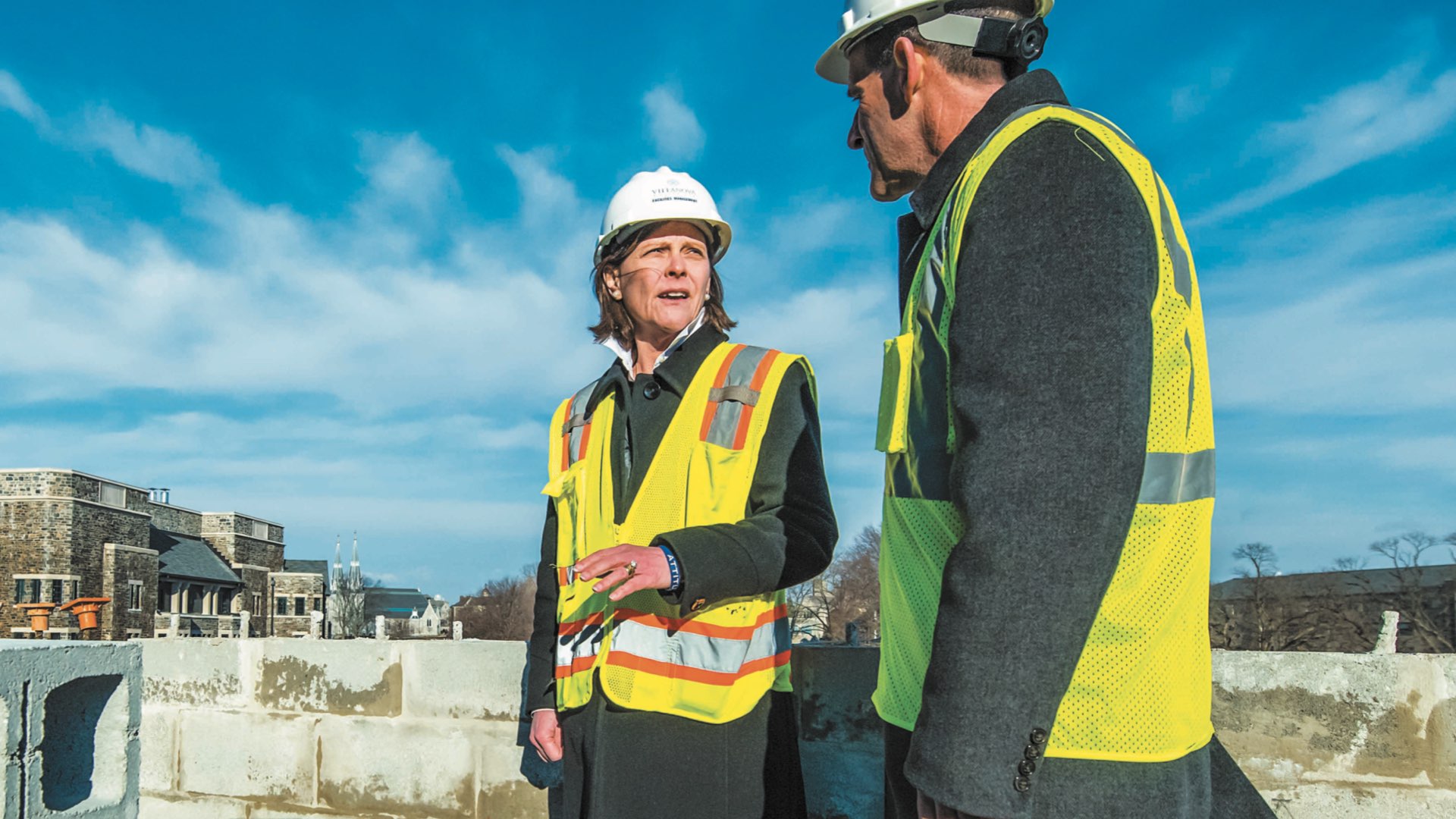 Marilou Smith ‘84 COE and Robert Morro on a construction site at Villanova wearing hard hats and safety vests