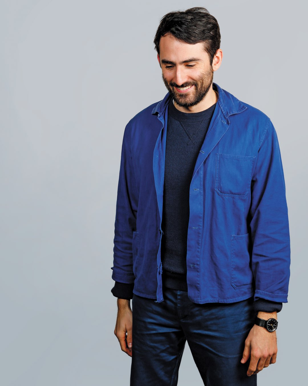 Villanova School of Business alumnus Ryan Burke with a beard in a blue denim button down and jeans