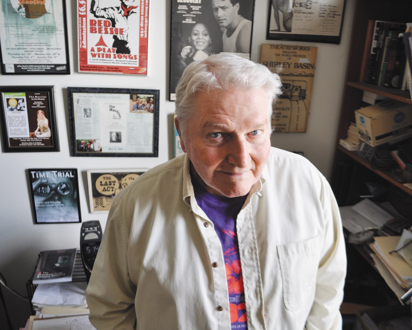 Villanova 1964 graduate alumnus Jack Gilhooley standing in front of several framed playbills in his office