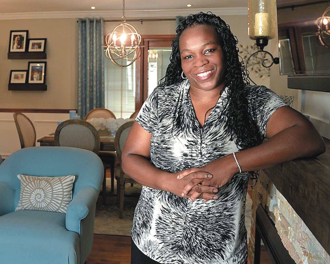 2000 alumna Lauren Nolan-Sellers standing in a client’s dining room with a modern design