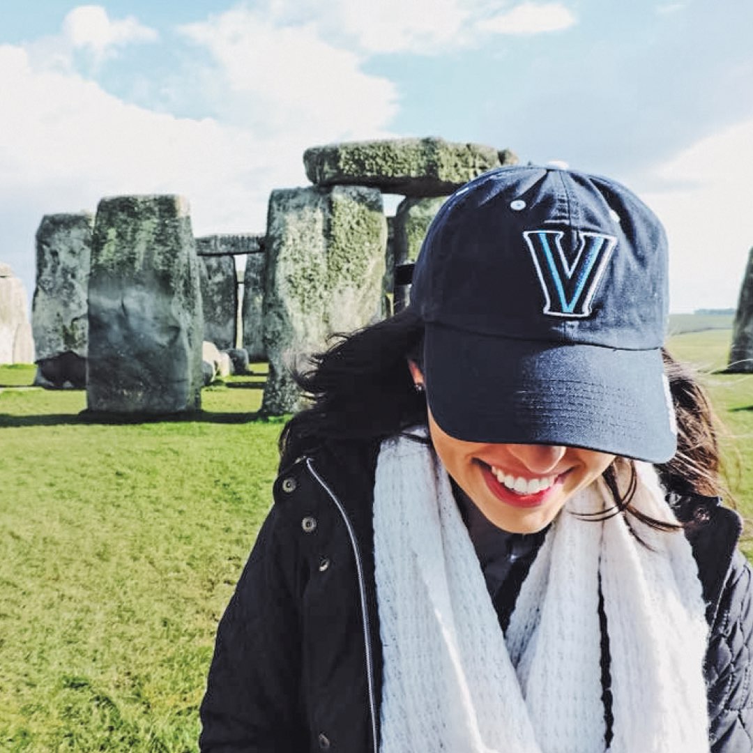 A female Villanova student  in Stonehenge, England wearing a Villanova hat