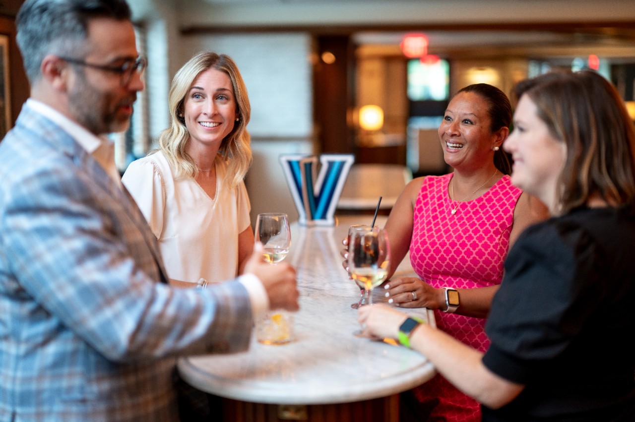 Alumni Workplace Engagement Program Alumni talking around a table