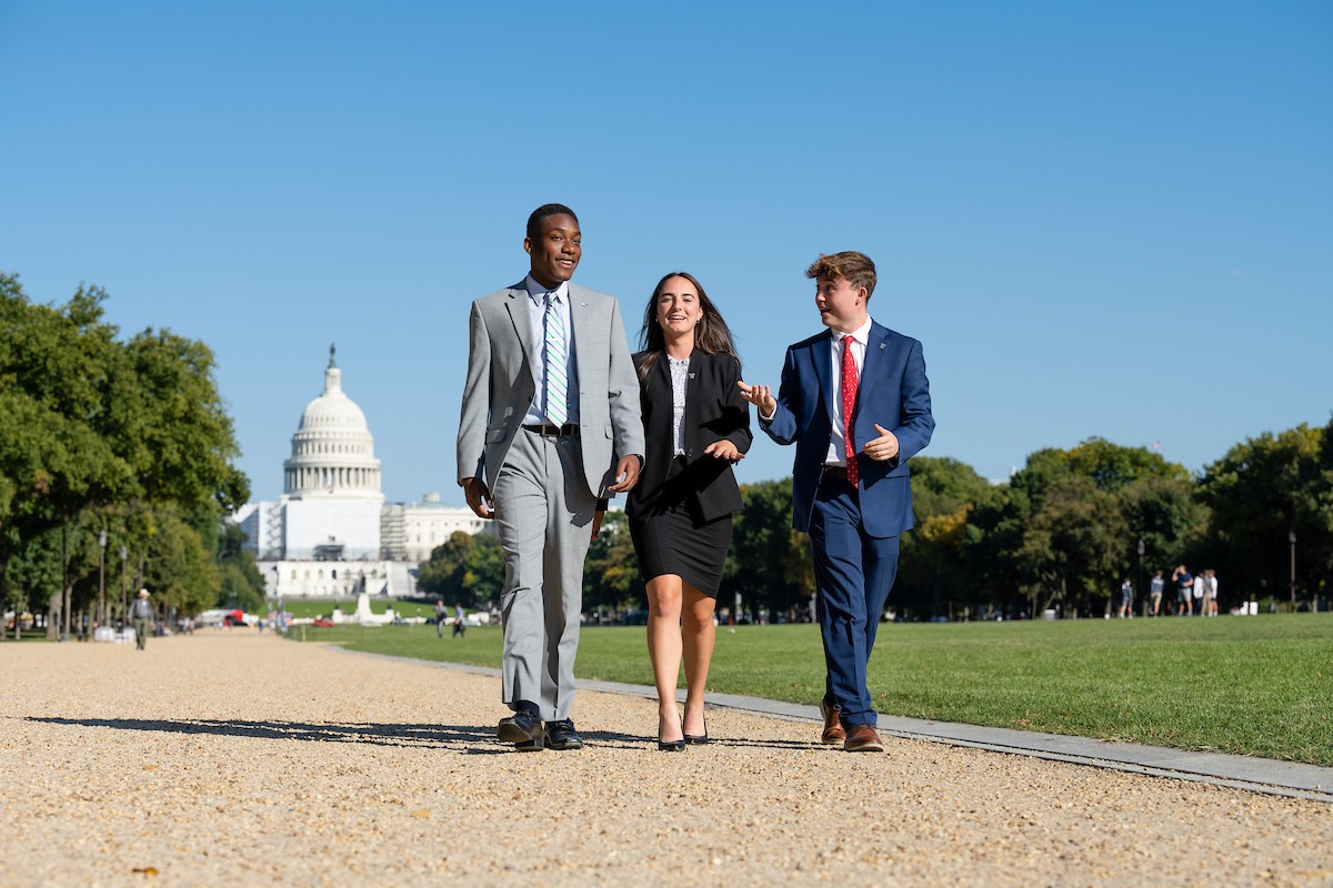CSP263_20221011_0010 Three students walking outdoors near the U.S. Capitol building in Washington, DC.