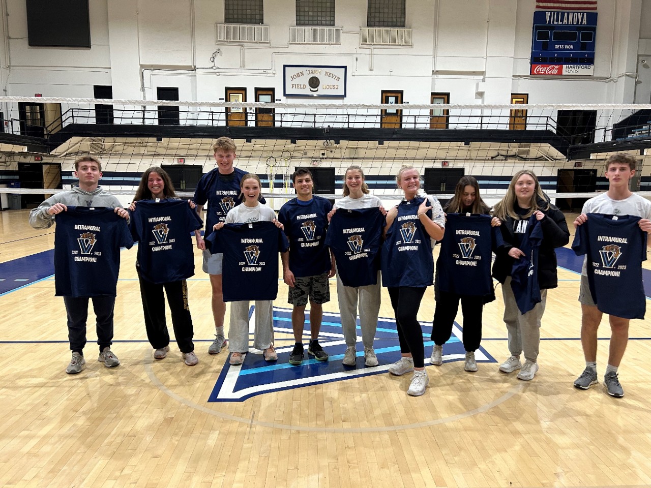 Students posing for volleyball champion photo