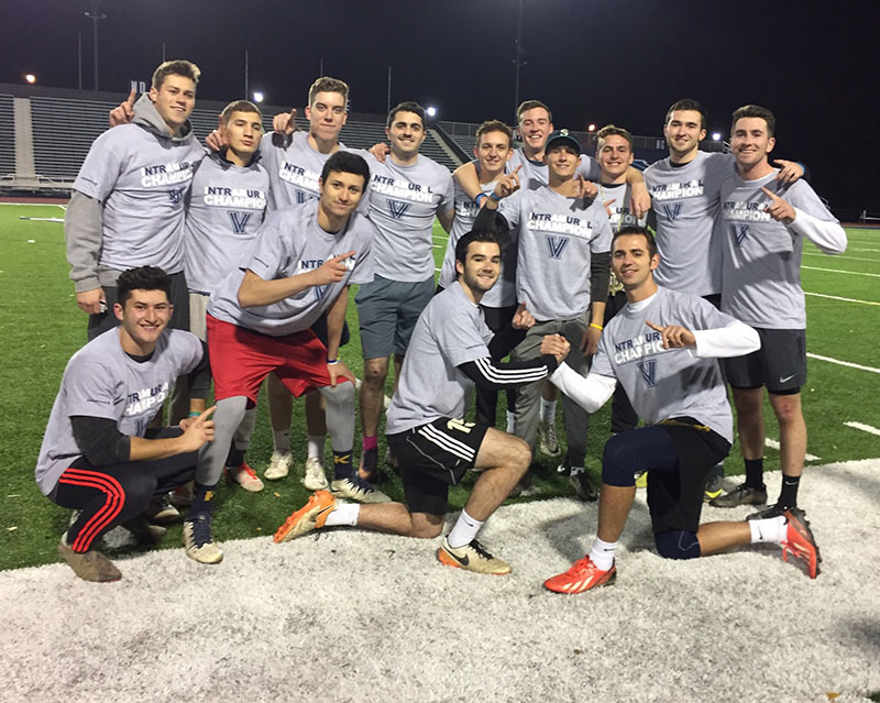 Male students posing for flag football champion photo