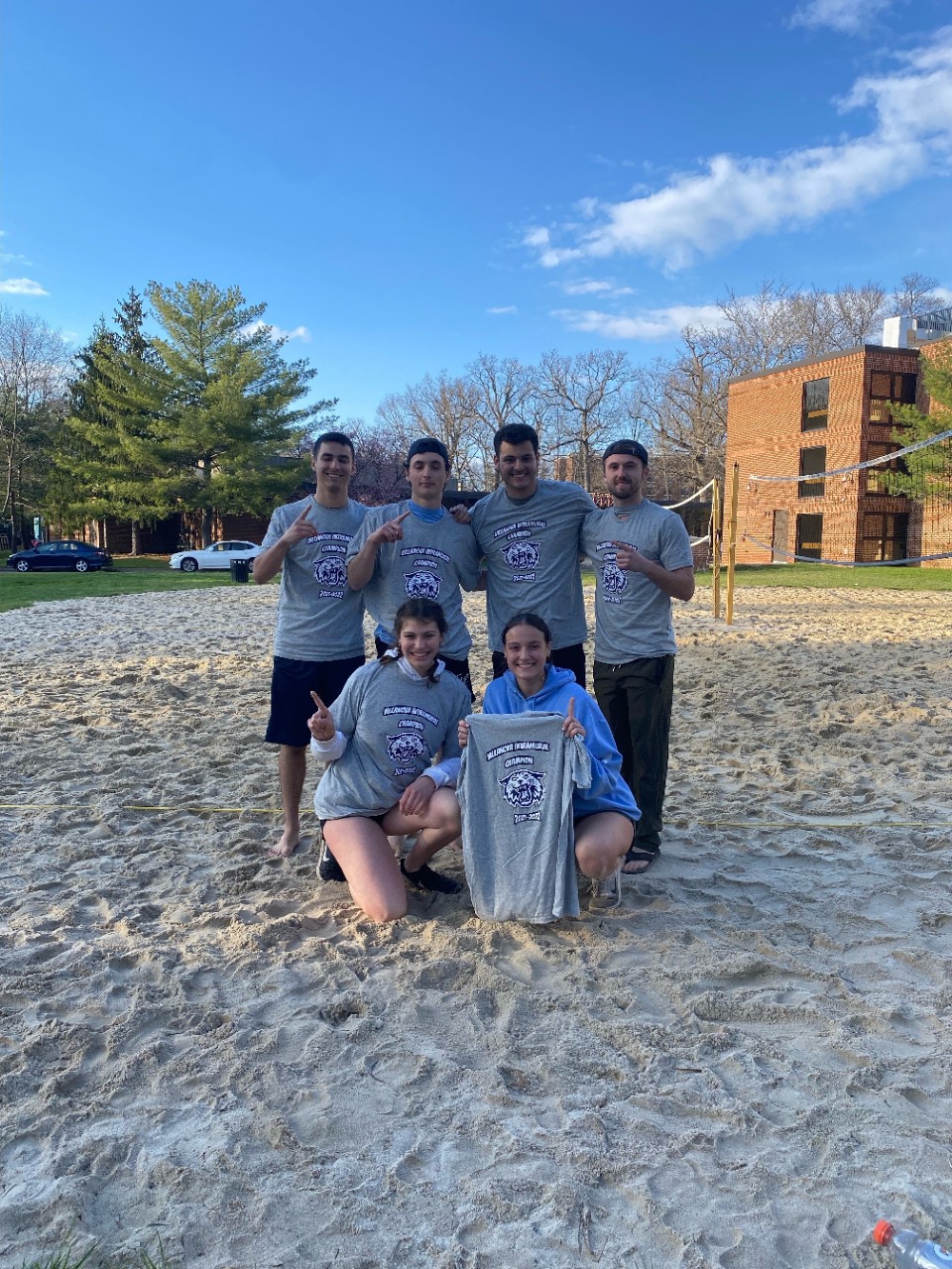 Students posing for sand volleyball champion photo