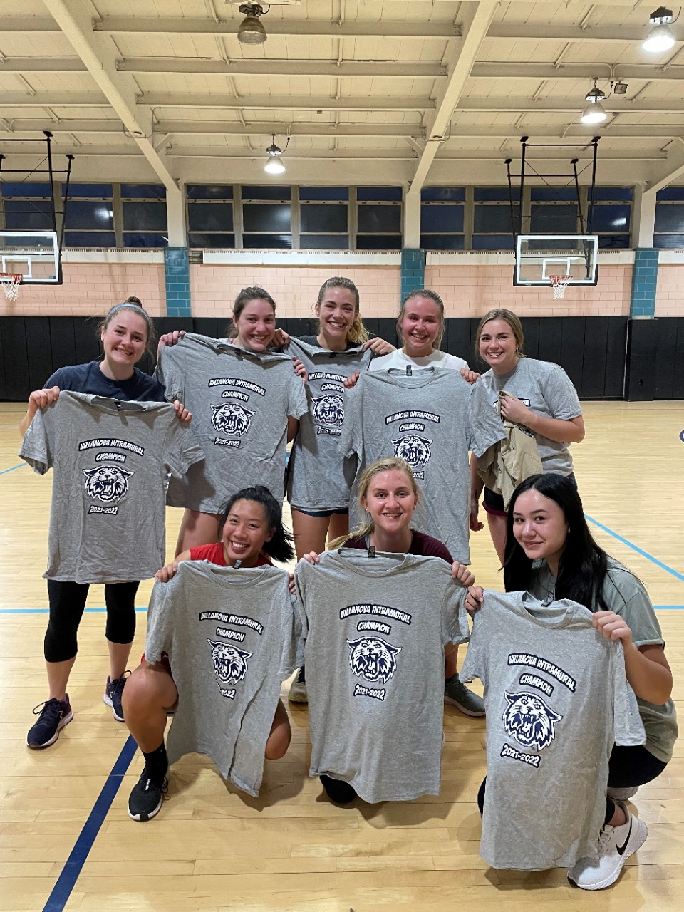 Female students posing for indoor soccer champion photo