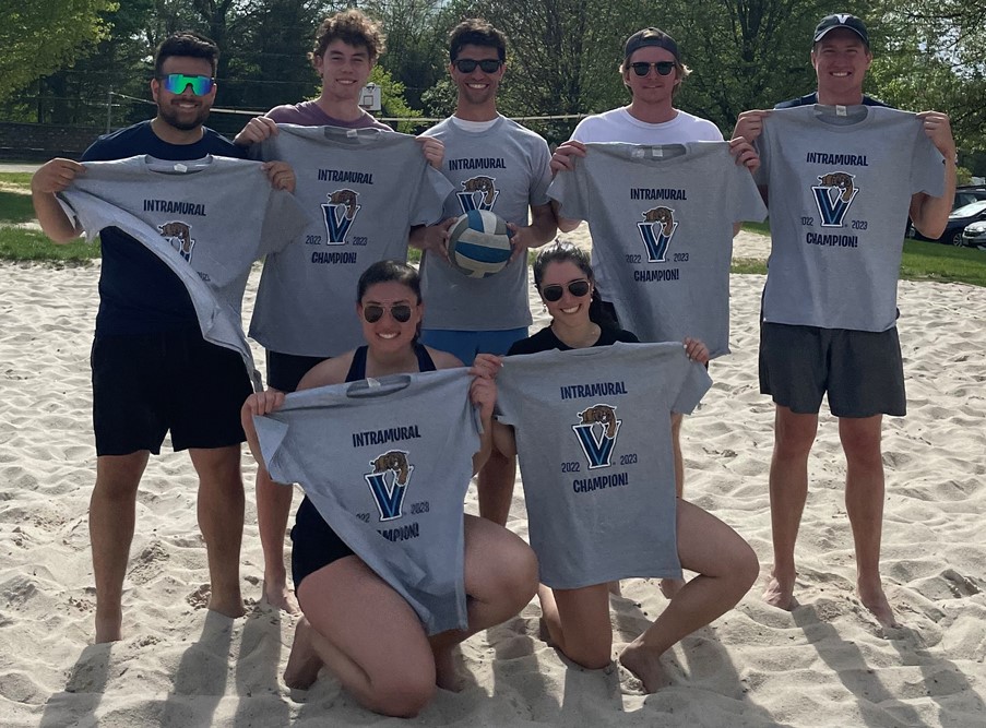 Students posing for sand volleyball champion photo