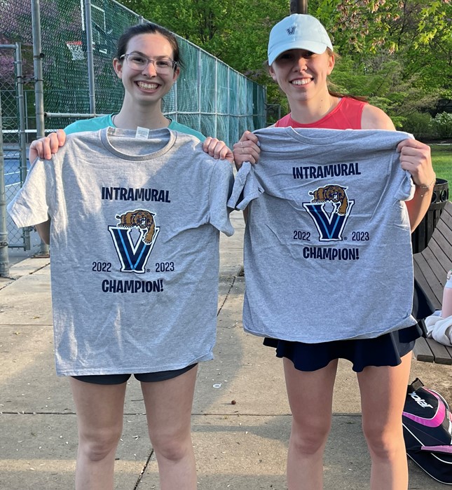 Two female students posing for doubles tennis champs photo