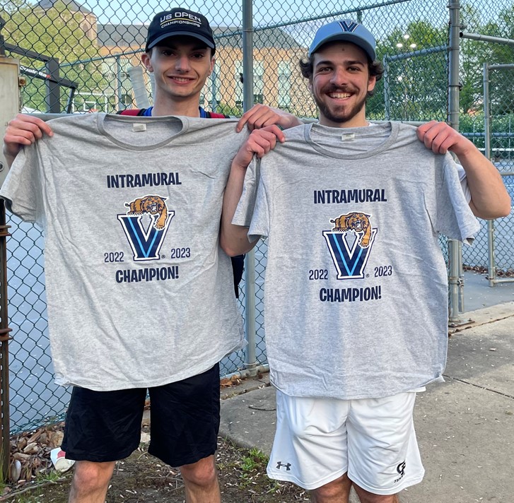 Two male students posing for doubles tennis champion photo