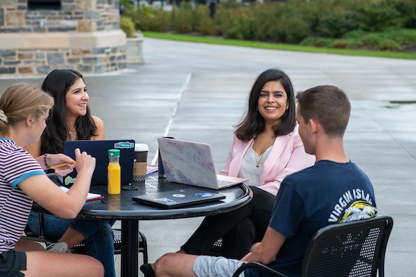 professor-students-sitting-outside Professor and students sitting