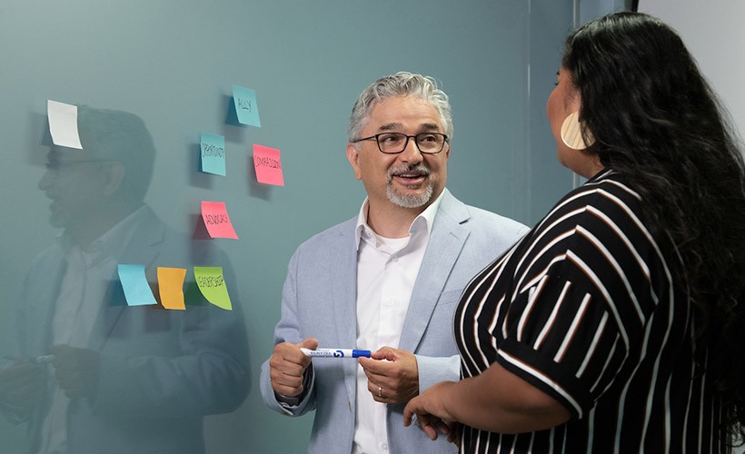 Ed Fierros, Associate Dean of Diversity, Equity and Inclusion, talks to a student.