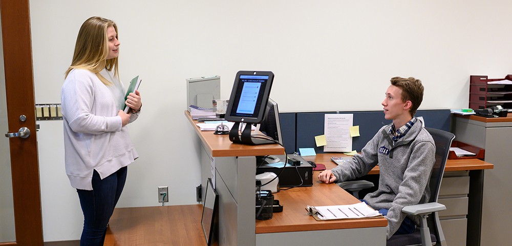 Graduate student checking in at the Math Center Graduate student checking in at the Math Center