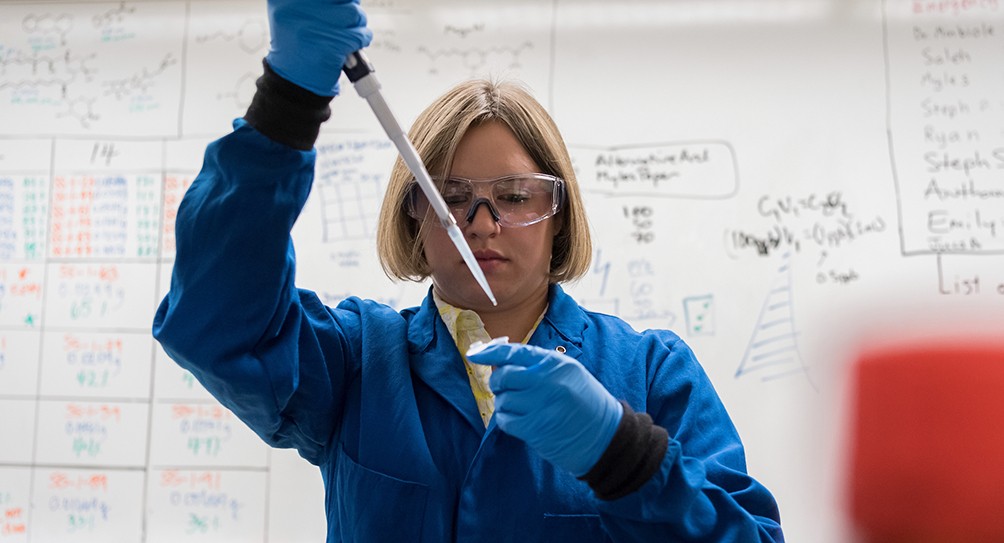 Chemistry master's student working in the lab Chemistry master's student working in the lab