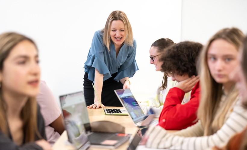 Students and professor conversing in a political science class. Students and professor conversing in a political science class.