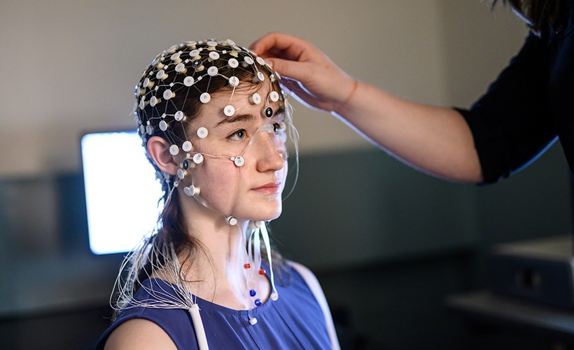 A student participates in a research experiment in a Psychology lab.
