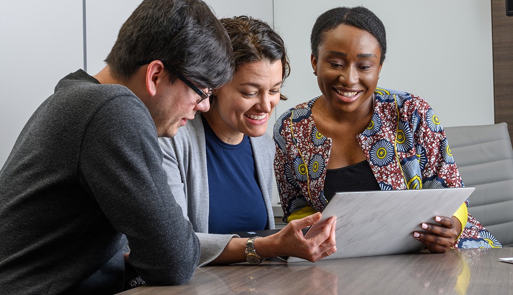 Theatre students in the nonprofit management track working on a group project sitting at a table