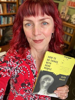 Alice Dailey holds her book, "How to Do Things with Dead People: History, Technology, and Temporality from Shakespeare to Warhol." Alice Dailey holds her book, "How to Do Things with Dead People: History, Technology, and Temporality from Shakespeare to Warhol."
