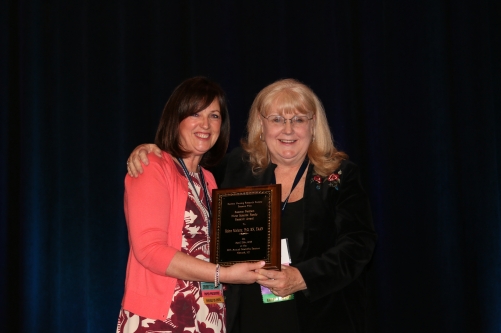 Dr. Helene Moriarty (right) receives the ENRS award.