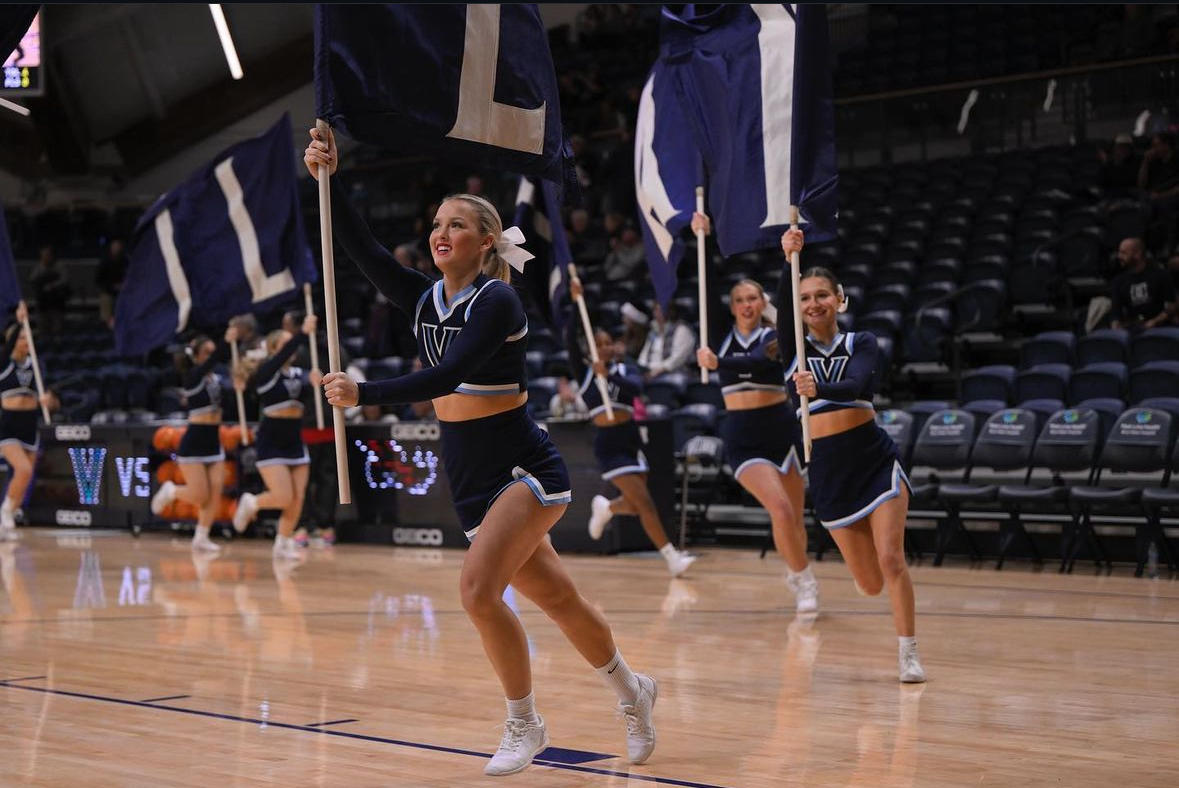 Mia Schnapf with flag as cheerleader