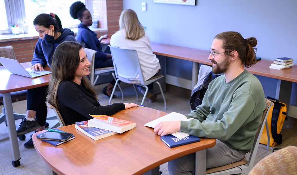 students sitting together at a table in the Writing Center