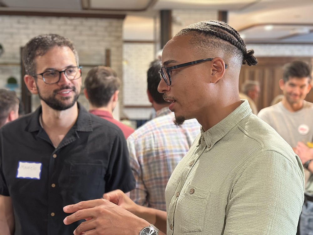 faculty speaking together at a reception