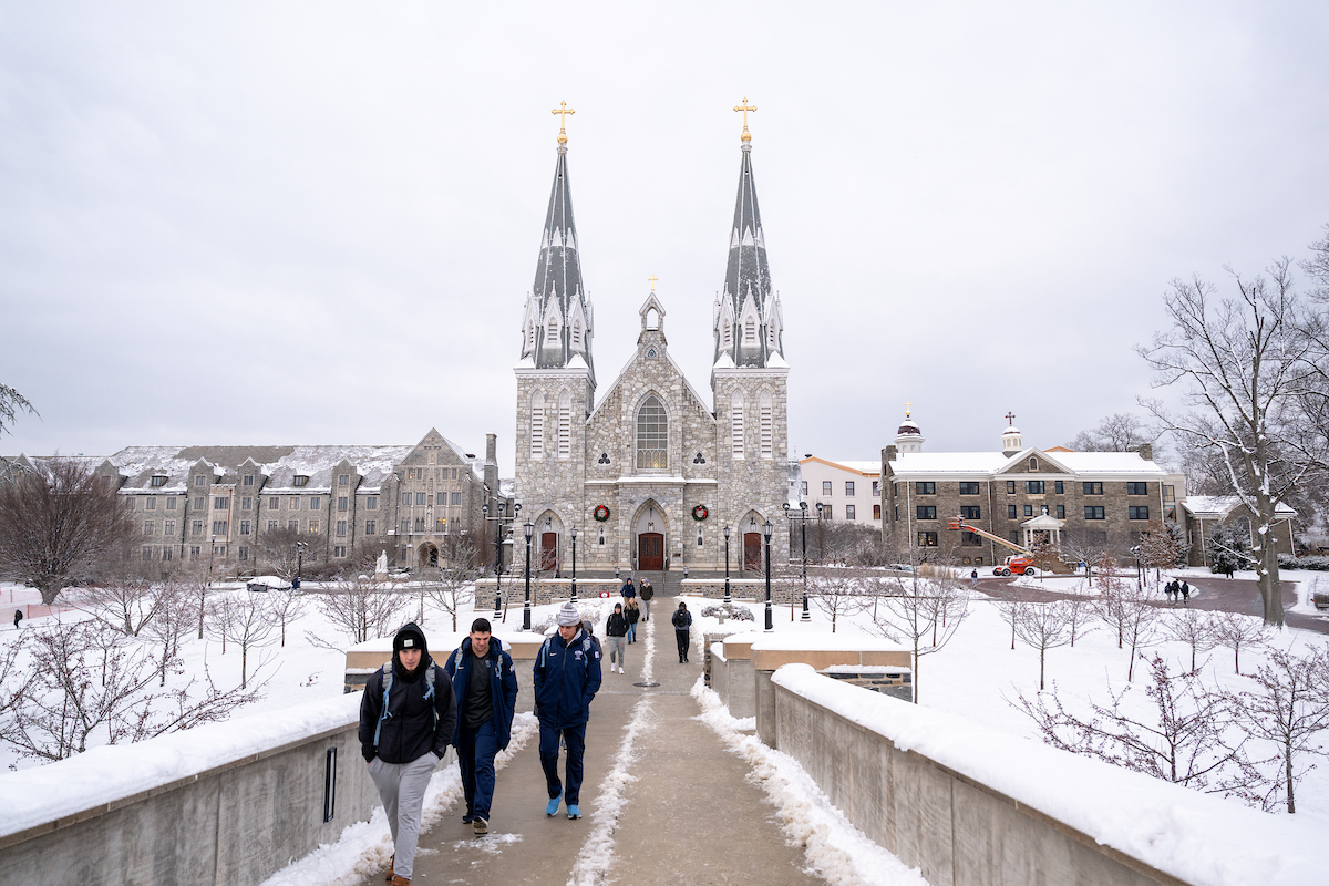 Students walk on a snowy campus
