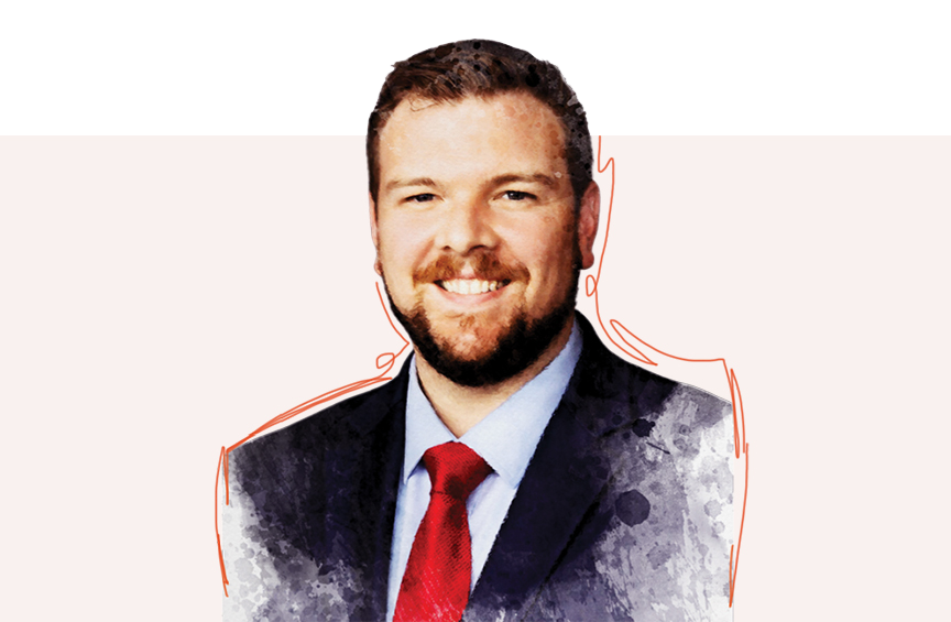 Headshot of Robert Duffy smiling directly at the camera wearing a dark blue suit with light blue shirt and red tie. 