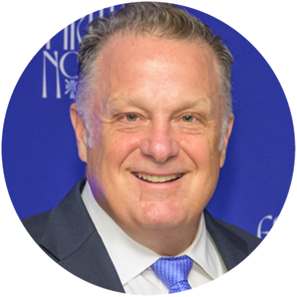 Headshot of Justin G. Gmelich smiling directly at the camera.